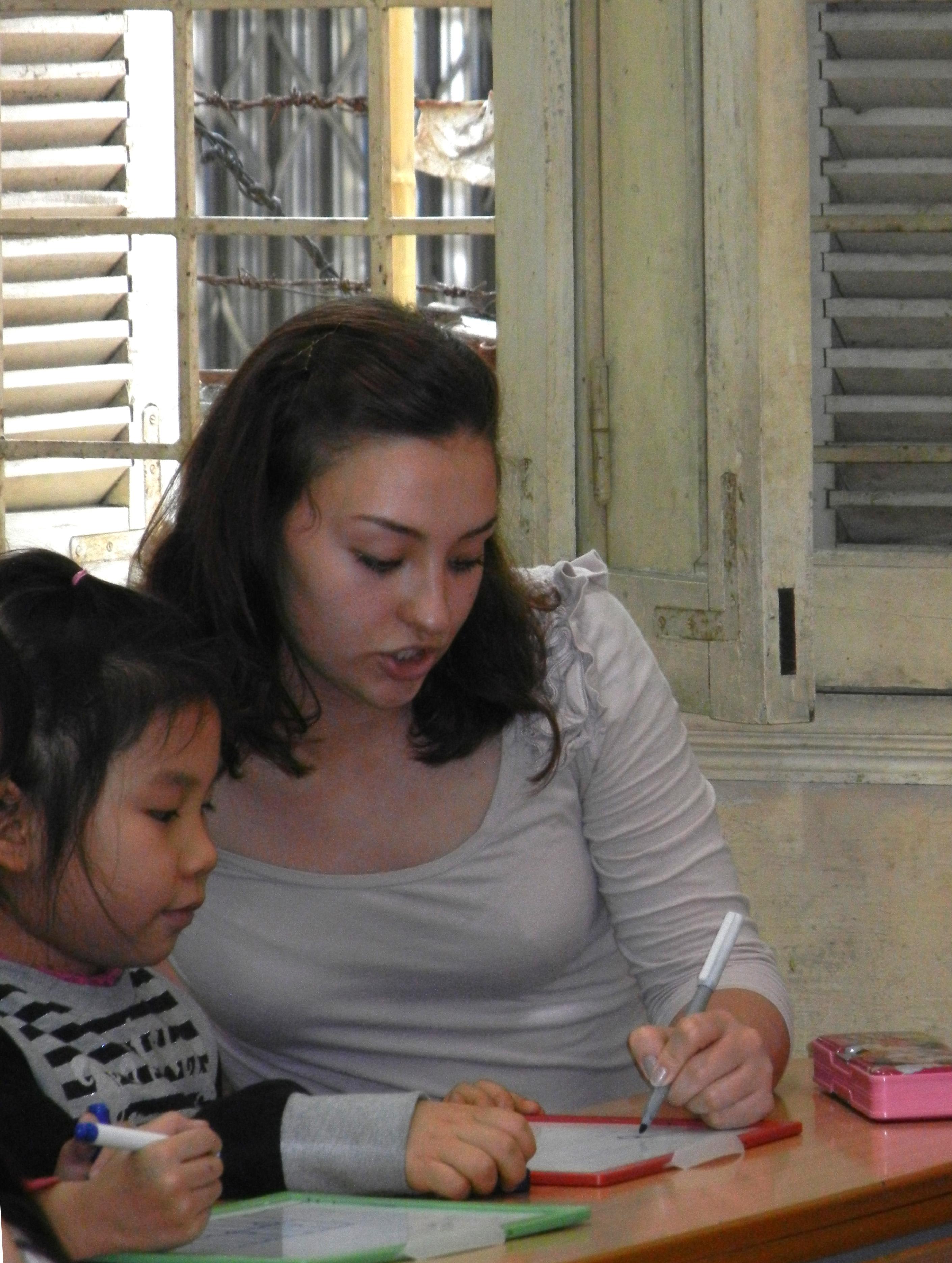 A female intern from Projects Abroad teaching a child how to read and write whilst on her speech therapy internship in Vietnam. An intern from Projects Abroad can be seen teaching a child how to read and write whilst on her speech therapy internship in Vietnam.